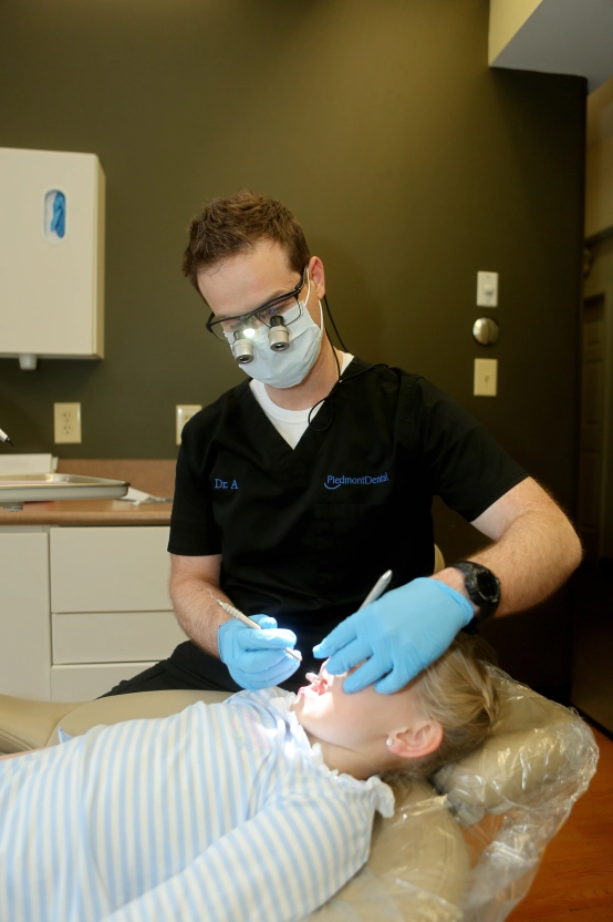 Dr. Areheart performing dental exam on patient