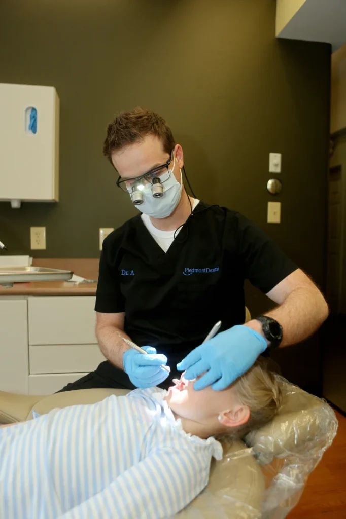 Dentist performing a routine teeth cleaning at his rock hill office