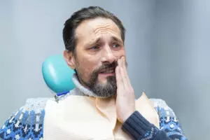 photo of man experiencing tmj pain