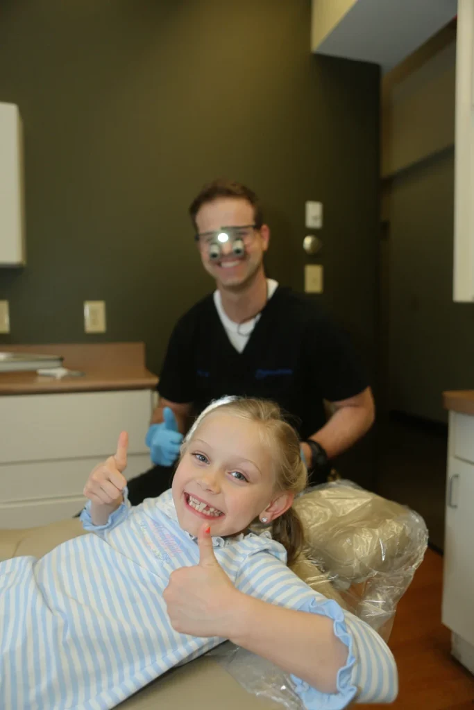 Child getting her teeth cleaned by dentist