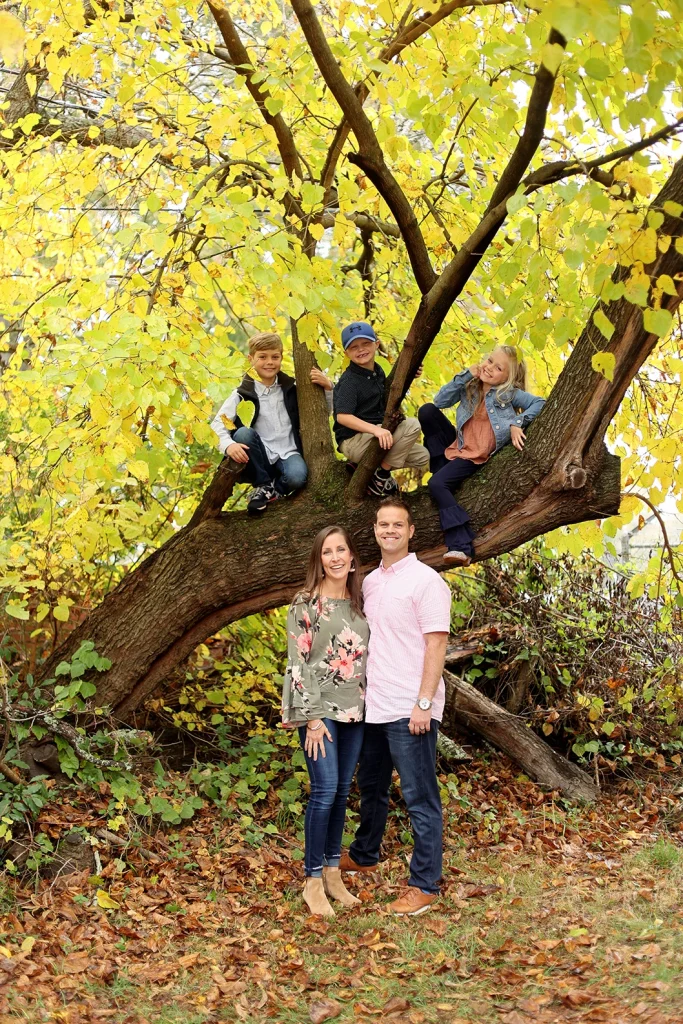 Dentist Dr. Benjamin Areheart standing with his wife and childen in a park in Rock Hill, SC