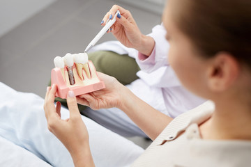 female being shown a dental crown