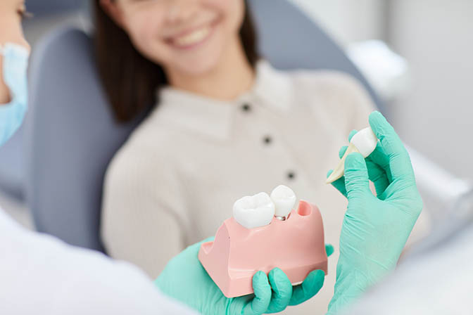 woman smiling while at a tooth extraction appointment