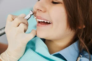 dentist removing tarter and plaque from teeth