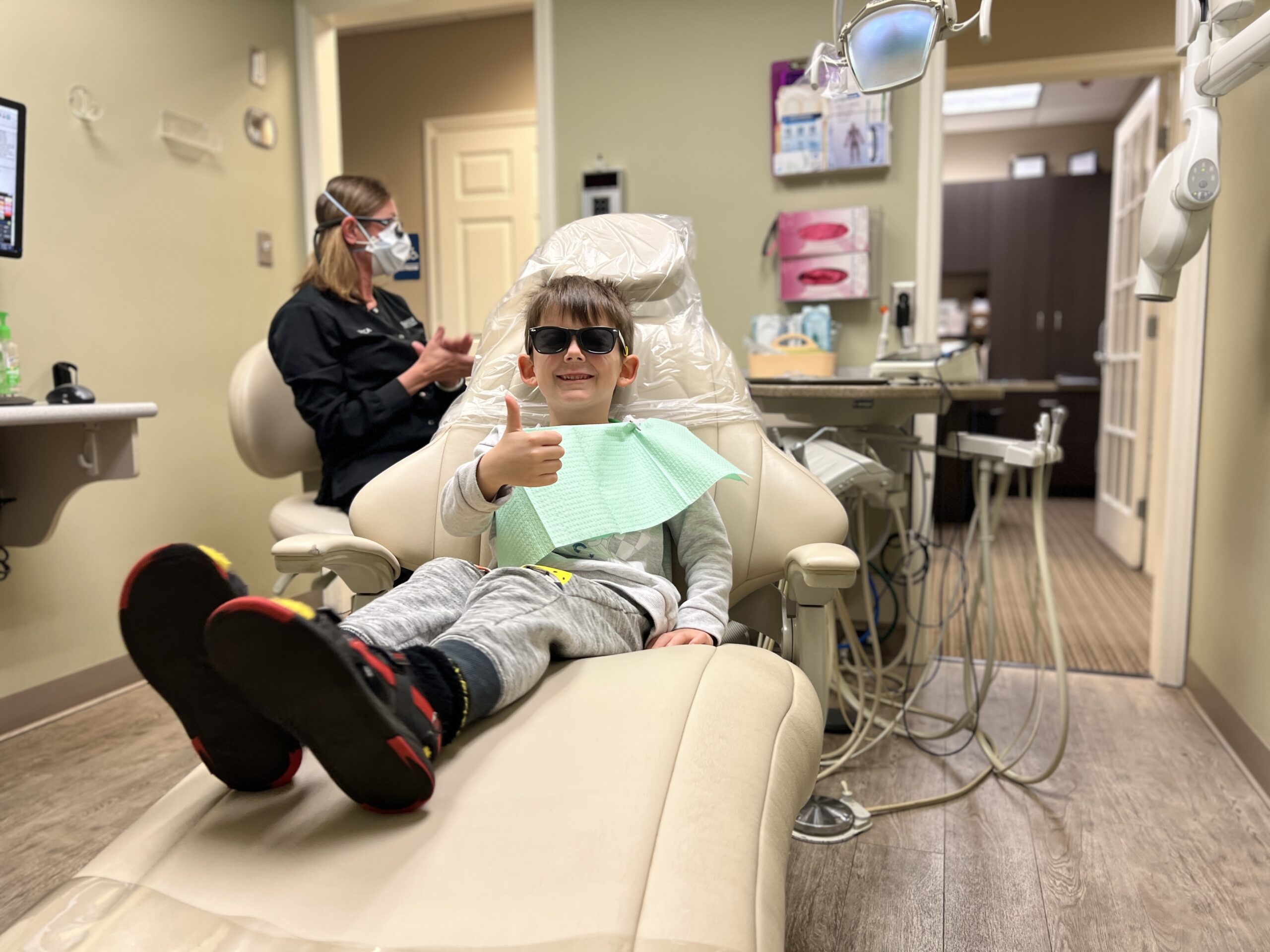A young patient giving a thumbs up after pediatric dentistry at Piedmont Dental in Rock Hill
