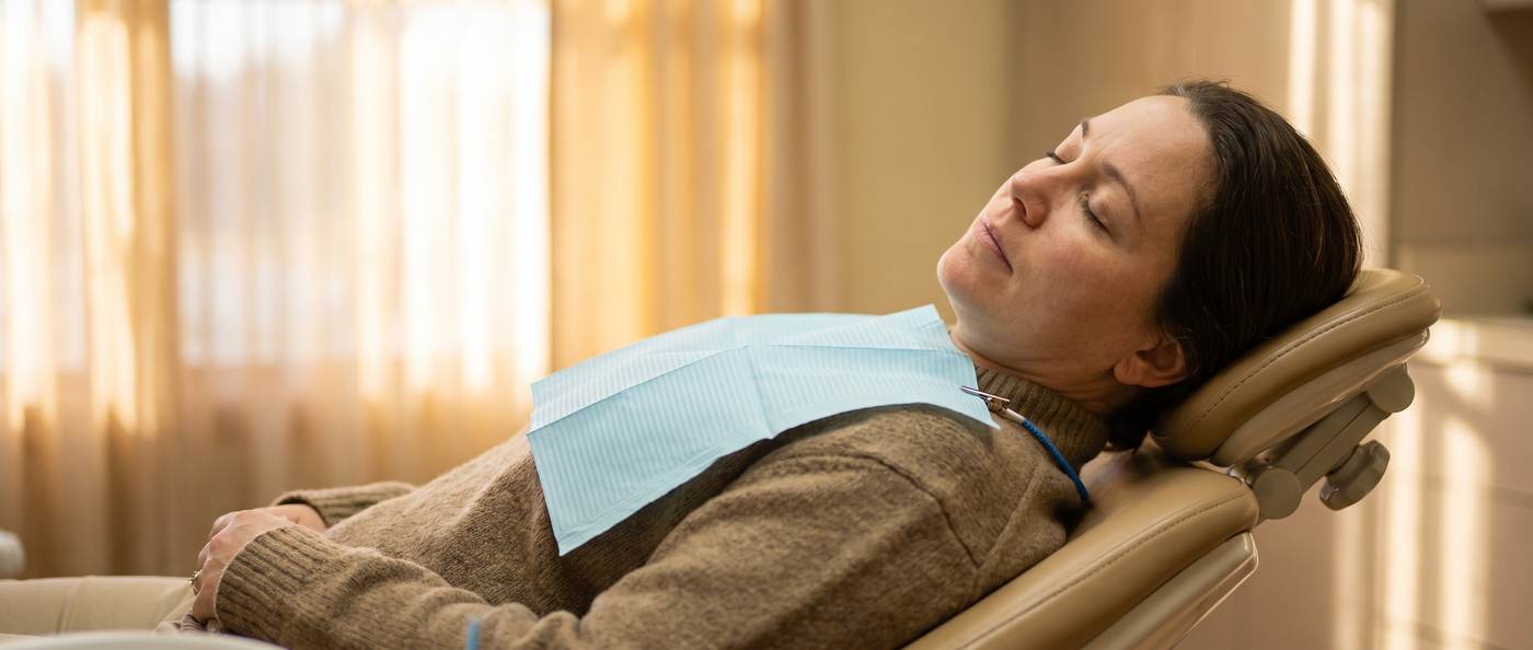 Patient resting comfortably in the dental chair during sedation